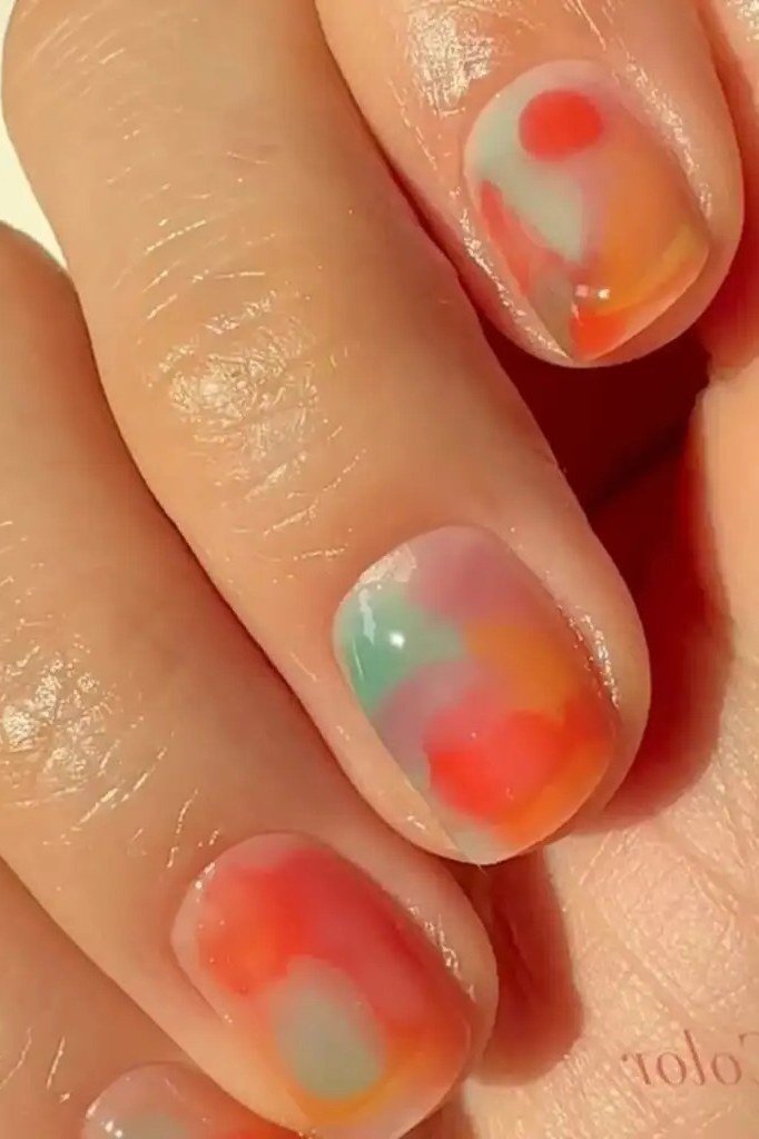 Watercolor jelly nails, orange and teal swirls, short - jelly nail idea for women over 60