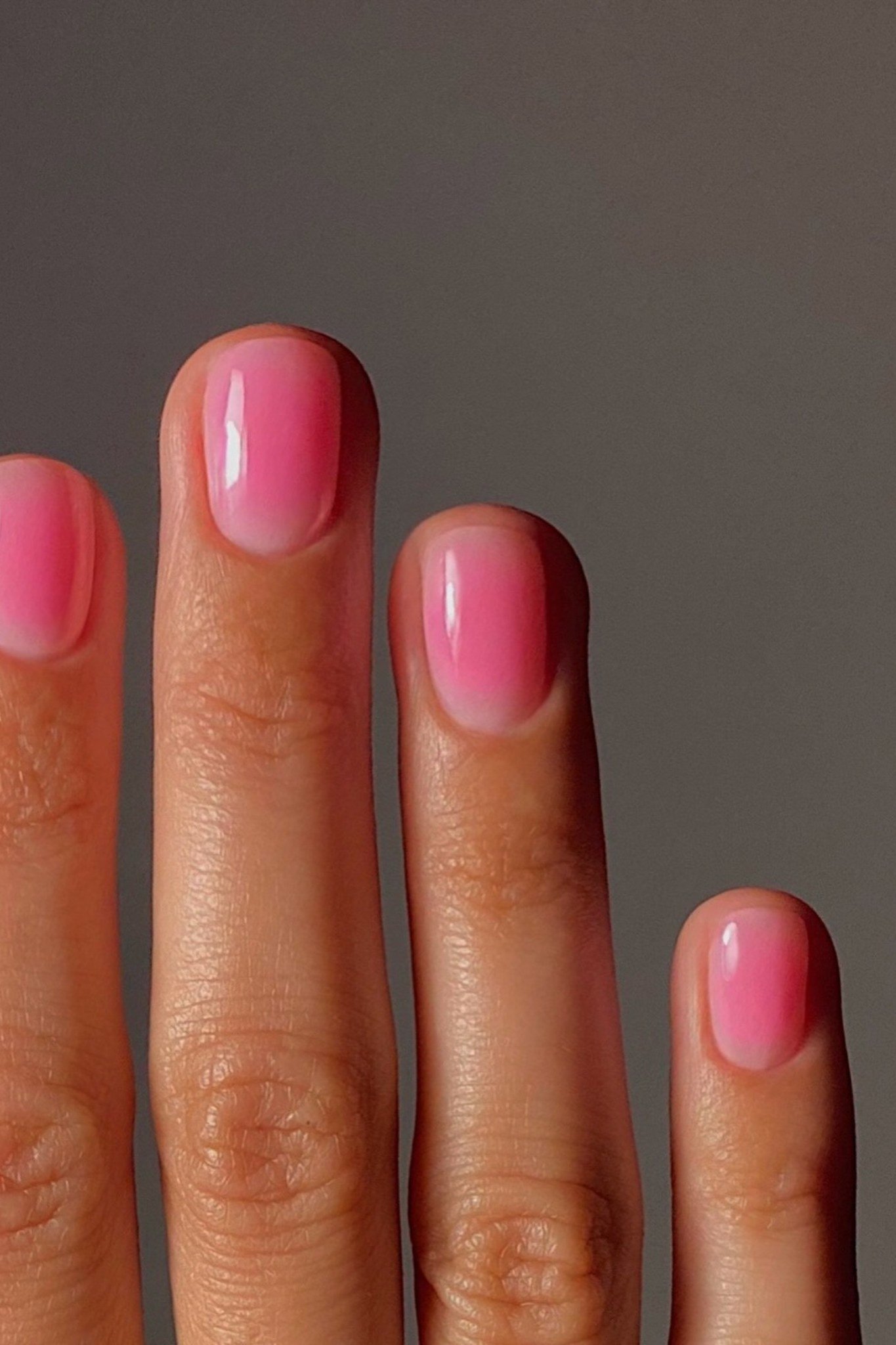Pink jelly nails, side view of hand, almond - jelly nail idea for women over 60