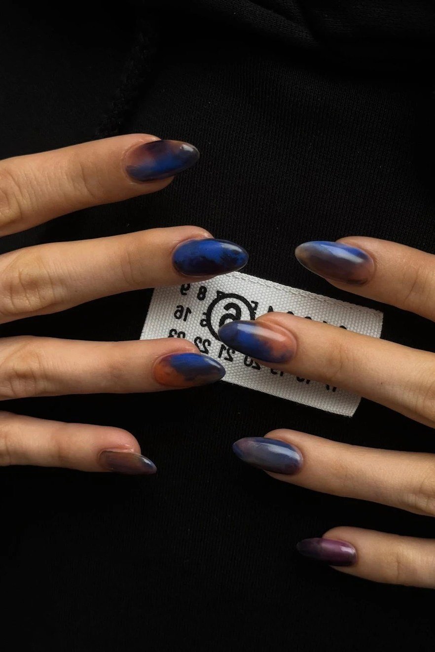 Dark blue cat-eye jelly nails, long, holding card - jelly nail idea for women over 60