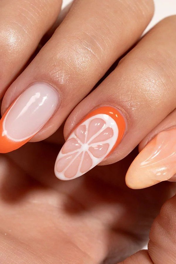 Jelly nails with orange citrus slice nail art and peach tips - jelly nail idea for women over 60