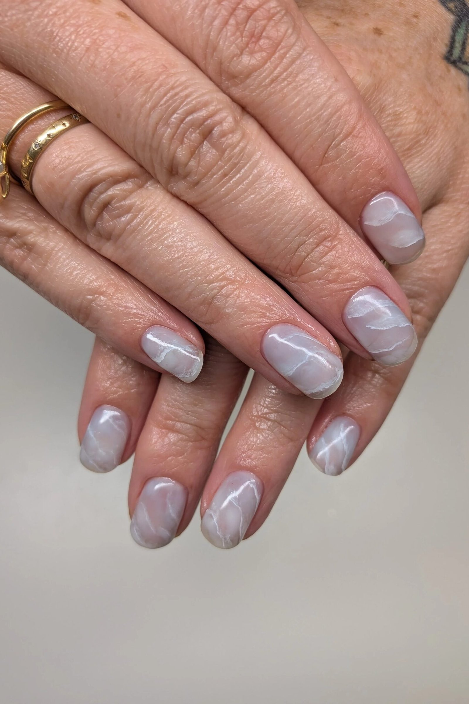 Soft White and Grey Marble on Short Oval Nails - marble nail design for women over 60