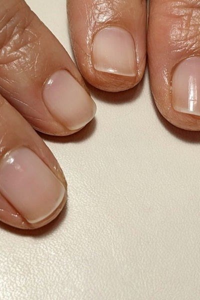 Closeup sheer nude natural nails, middle-aged hands for women over 60 - simple clear nail idea 2