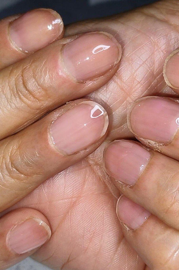 Closeup sheer pink glossy natural nails for women over 60 - simple clear nail idea 3