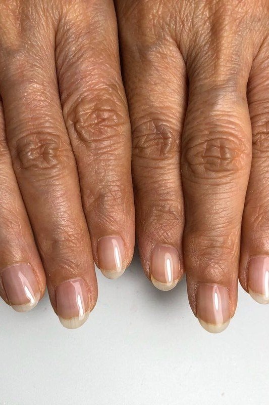 Mature hands, natural sheer french-tip look for women over 60 - simple clear nail idea 27