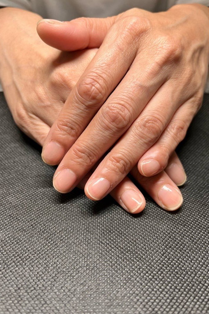 Crossed hands, sheer peach for women over 60 - simple clear nail idea 29