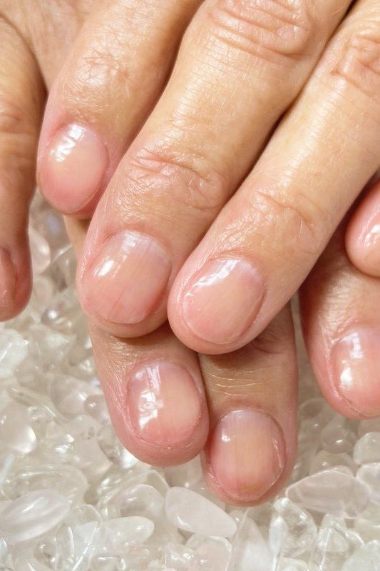 Hands with rings, glossy sheer pink for women over 60 - simple clear nail idea 31