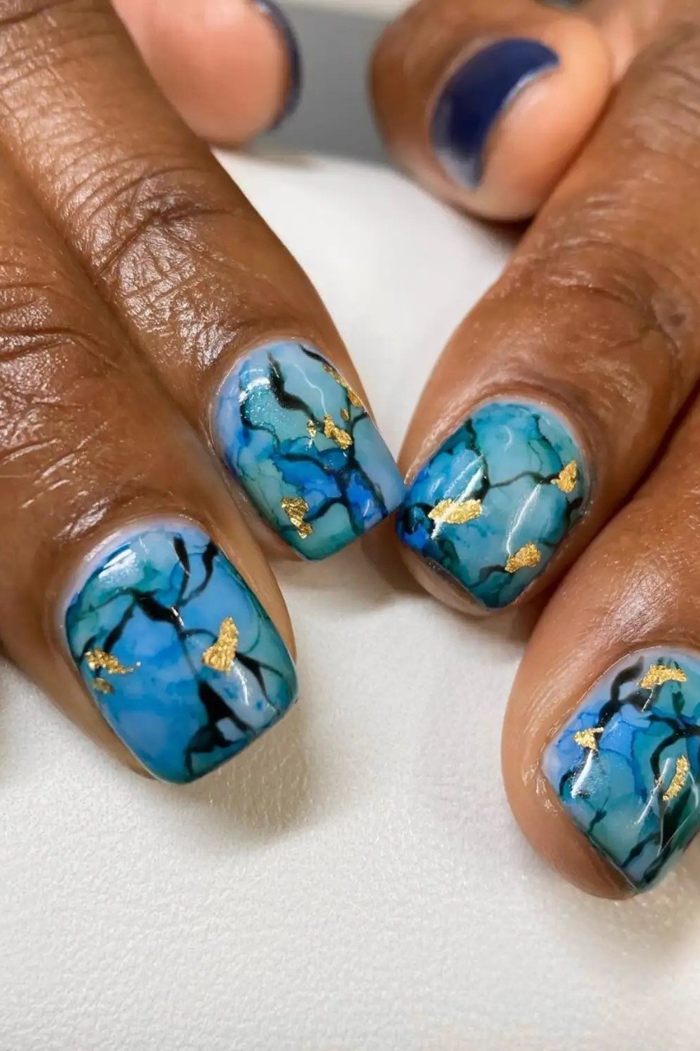 Turquoise Marble with Gold Flecks - marble nail design for women over 60
