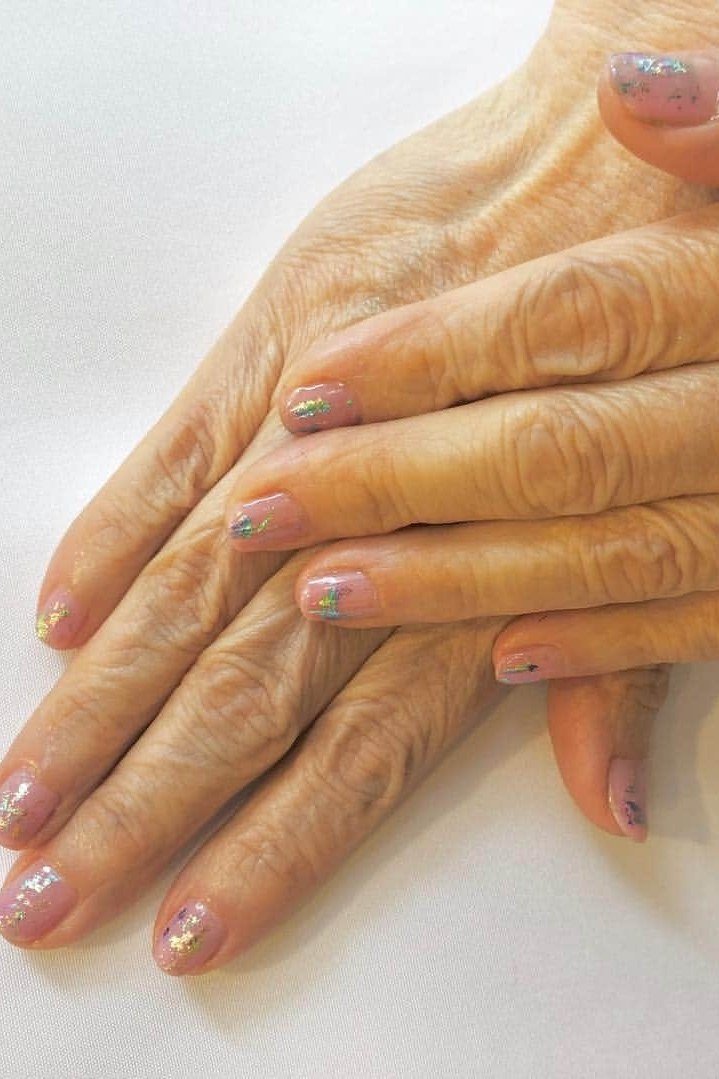 Hands, glitter tips on sheer base for women over 60 - simple clear nail idea 55