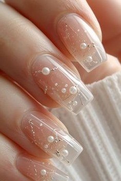 Young hand, pearls encapsulated in clear long nails for women over 60 - simple clear nail idea 66