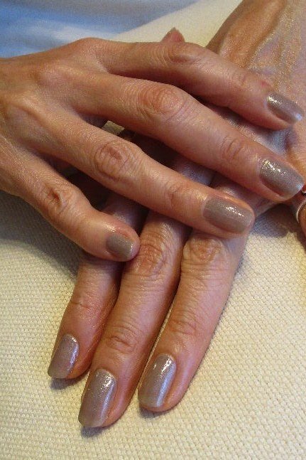 Taupe cream manicure on aged hands