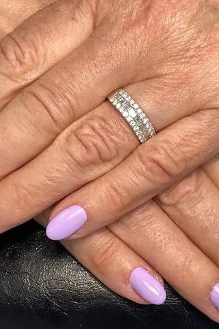 Soft lavender polish on mature hands