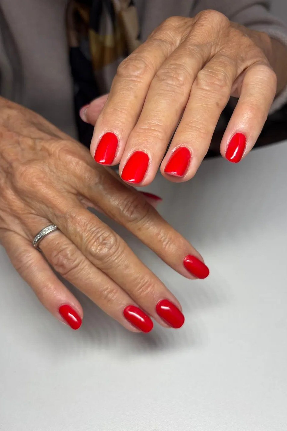 Short cherry red square nails glossy manicure for women over 60
