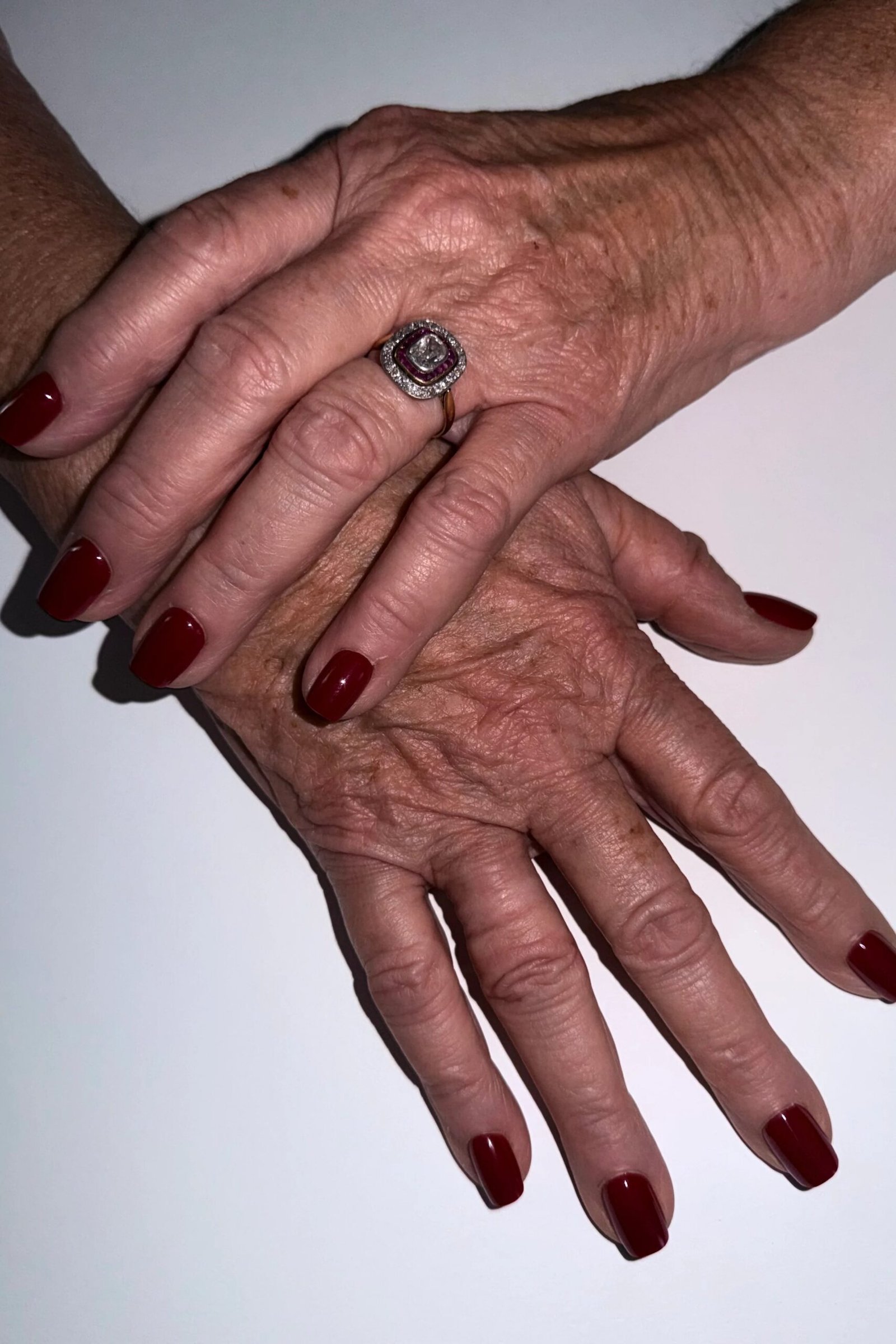 Deep red manicure shared across generations for women over 60