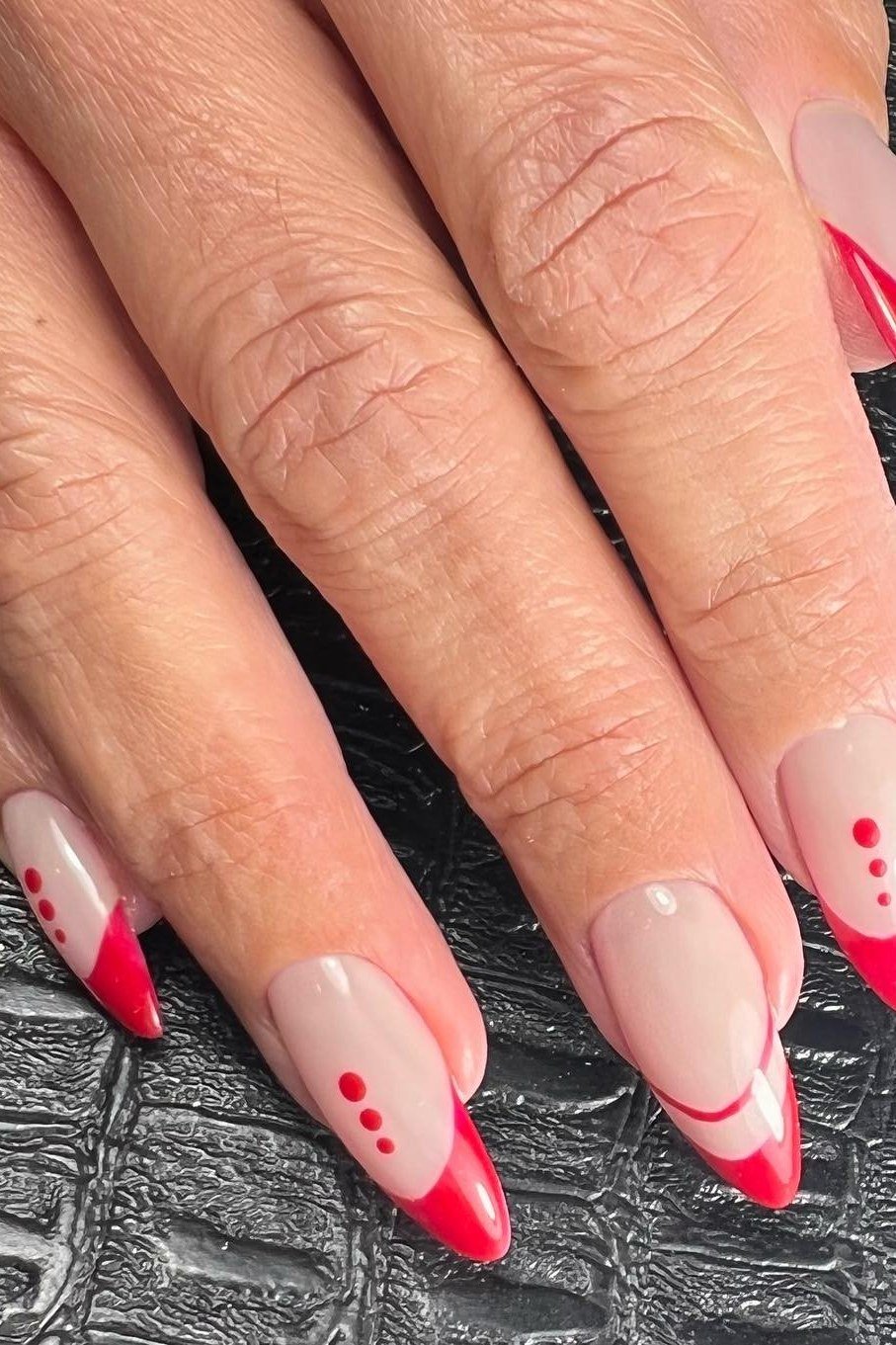 Red french tip nails with red dot art on nude base for women over 60