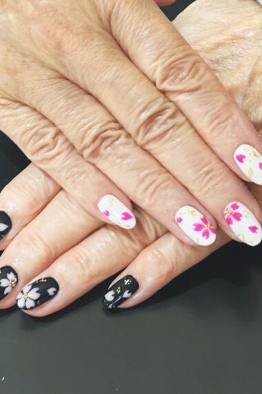 White Nails with Pink Flowers and Black Accent Nails - manicure idea for women over 40