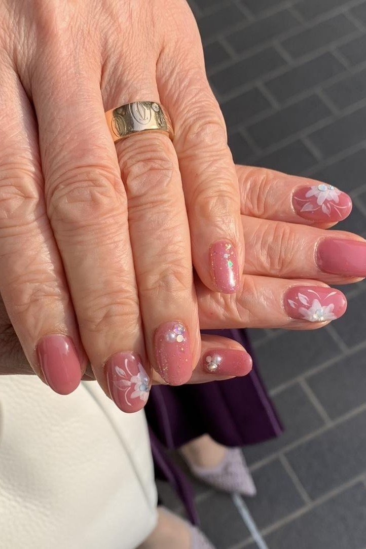 Coral Pink Nails with Tiny Flower Accents - manicure idea for women over 40