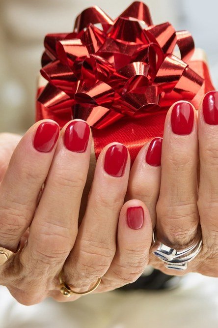 Red Nails with Gift Bow Holiday Styling - manicure idea for women over 40