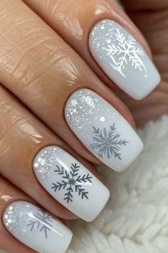 Silver glitter nails with light blue snowflake accents for mature women