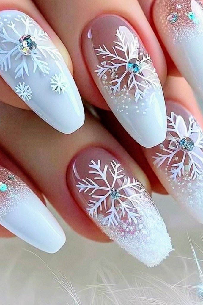 Baby blue almond nails with white snowflakes and crystal accents