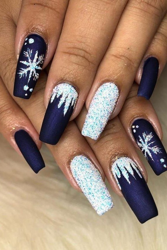 Navy blue nails with silver glitter snowflake accents, winter night design