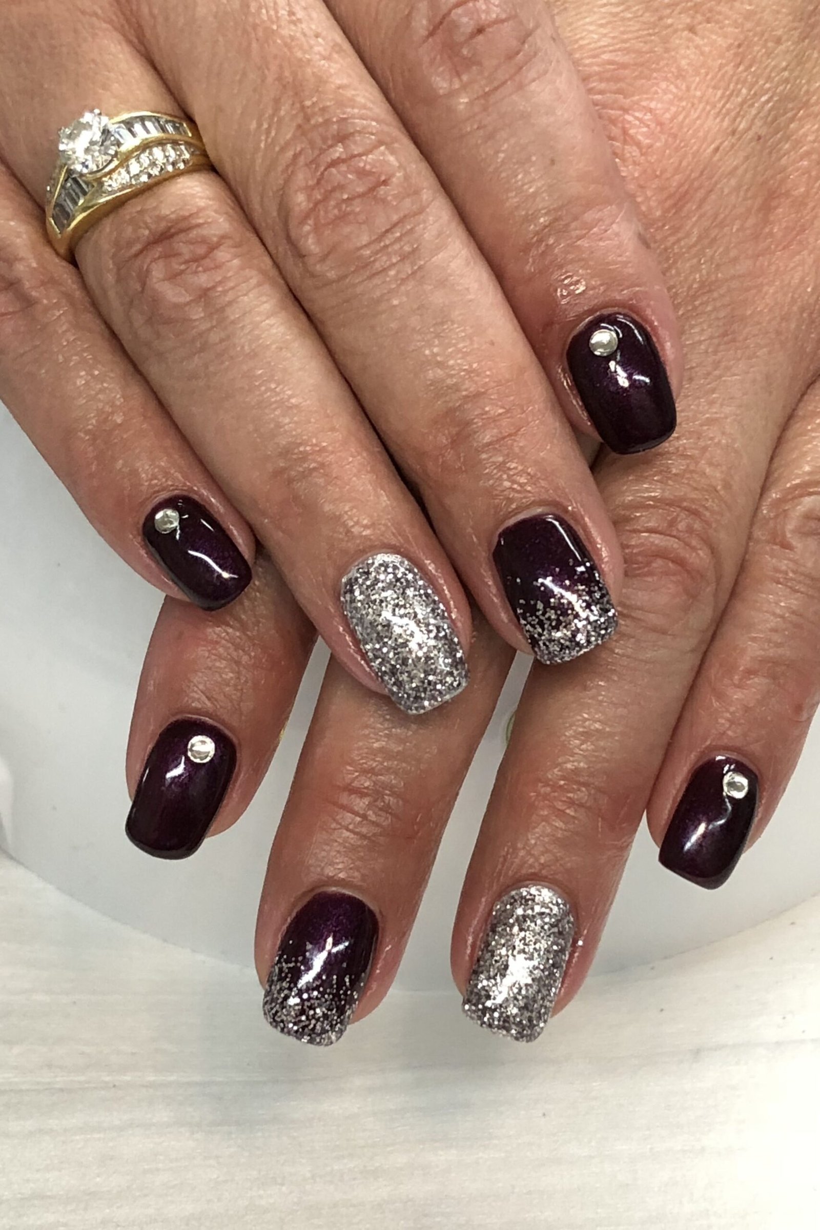 Black plum nails with silver glitter accent nails for mature women