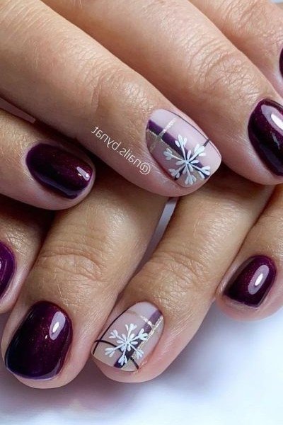 Deep plum nails with white snowflake accent nail, winter design
