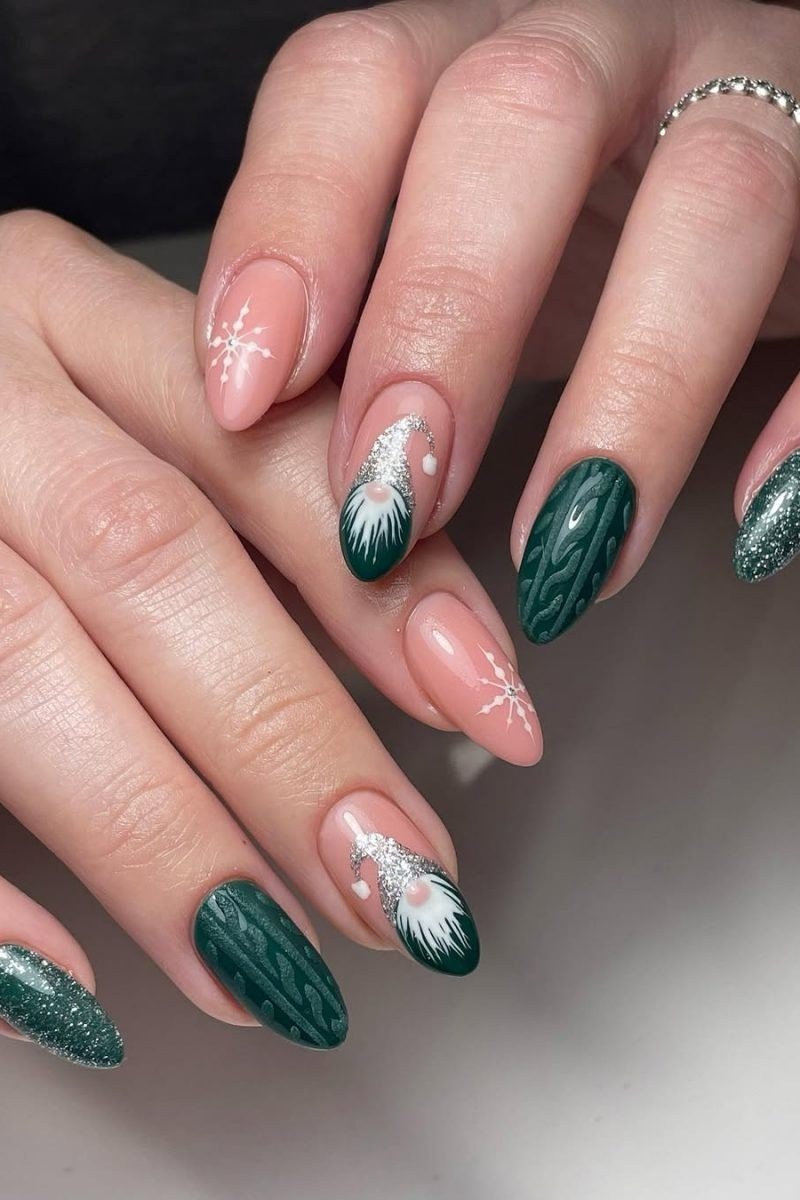 Deep green and blush pink nails with white snowflake art