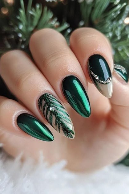 Green chrome nails with delicate leaf nail art, winter design