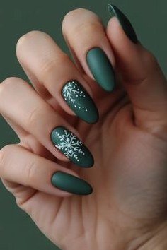 Matte green nails with glitter snowflake accent nail