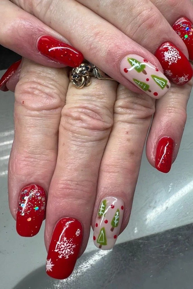 Red nails with snowflake holly and Christmas tree nail art for women over 60