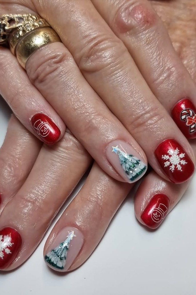 Red nails with white snowflakes and tiny Christmas tree art