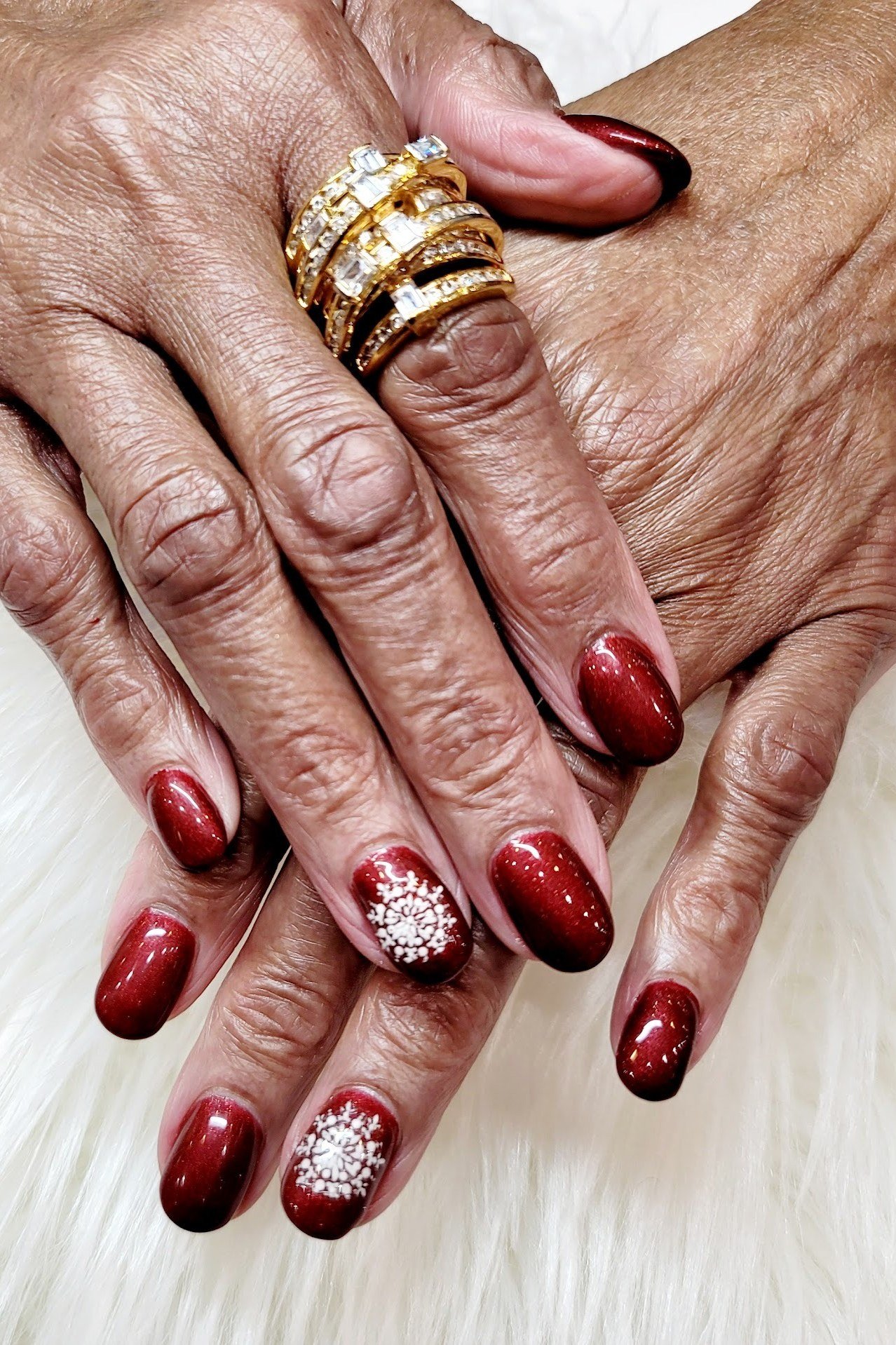 Red nails with white snowflake accent nail, simple festive manicure