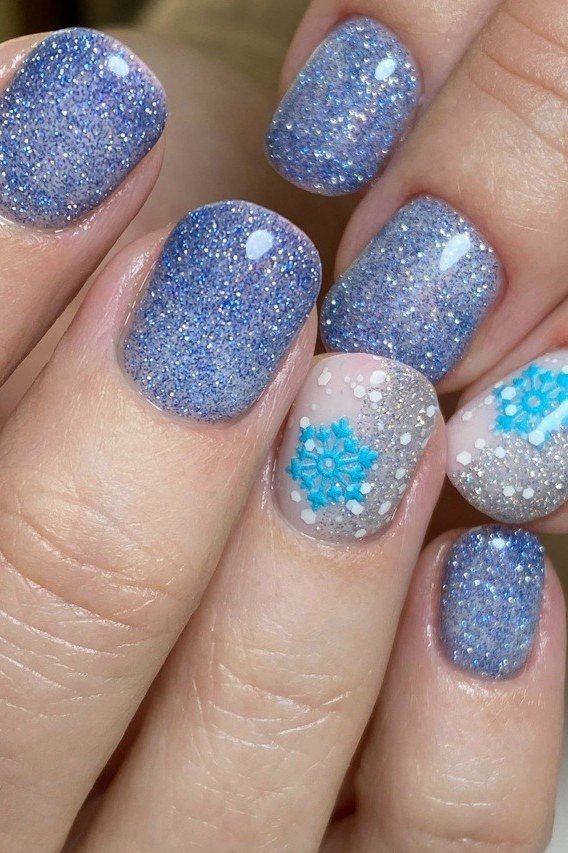 Periwinkle blue glitter nails with white snowflake art
