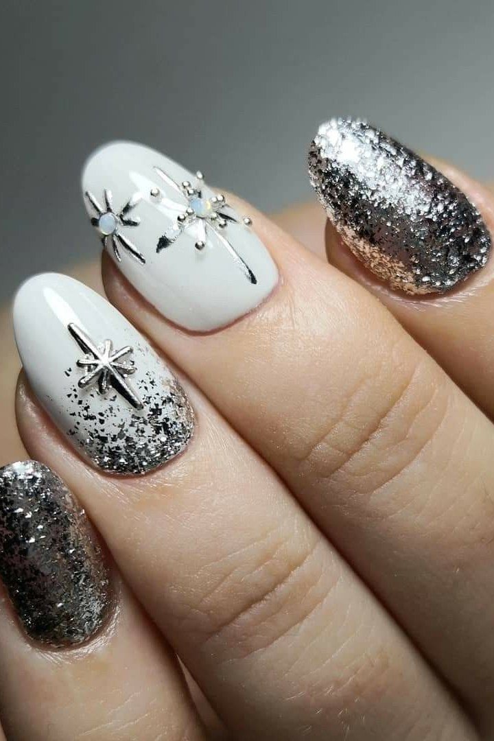 Silver glitter nails with black and silver starburst art, new year nails