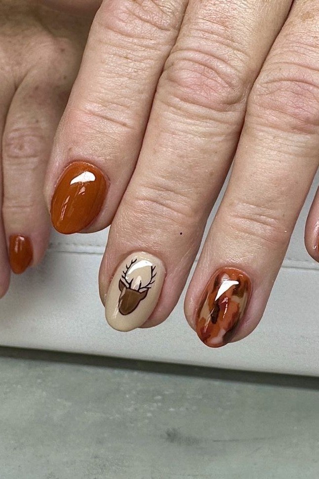 Burnt Orange with Deer and Tortoiseshell Accents on short oval nails for women over 60