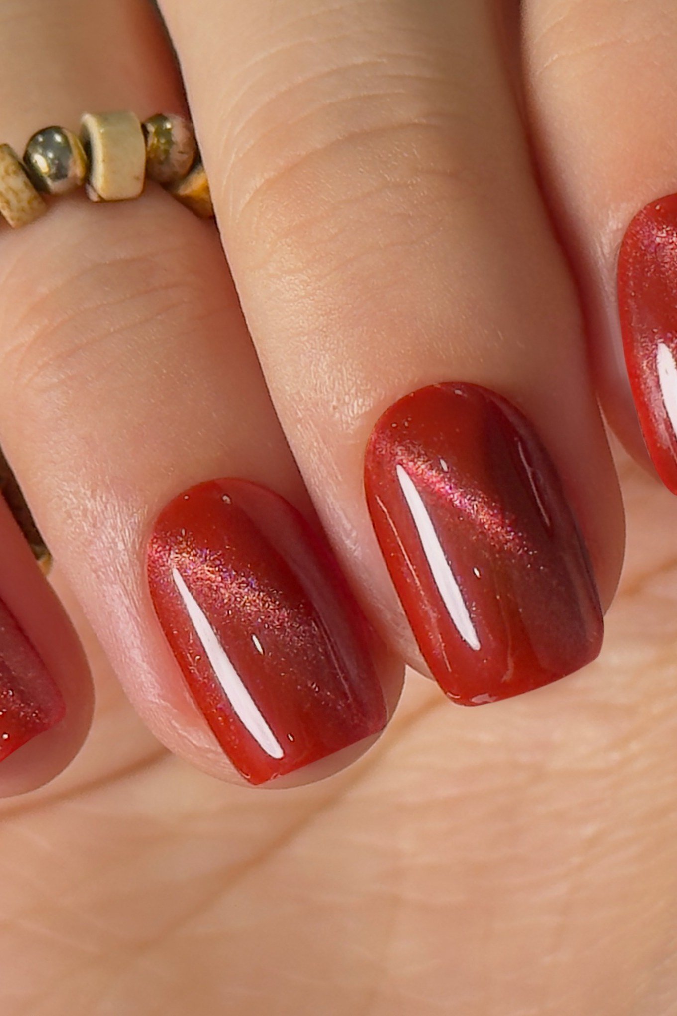 Red Cat-Eye on short oval nails for women over 60