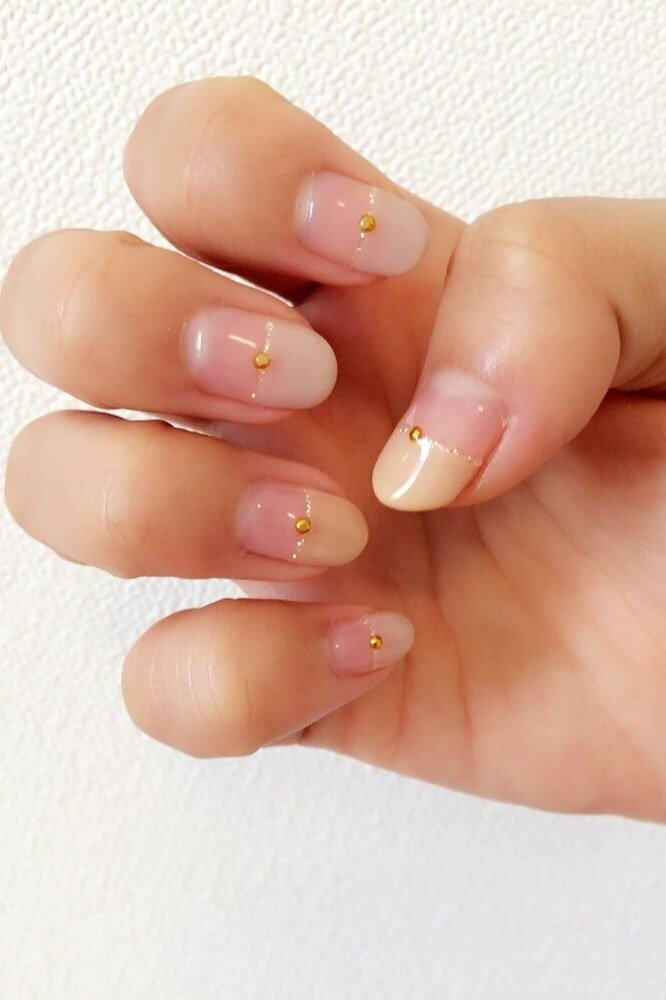 Nude with Gold Dot Accents on short oval nails for women over 60