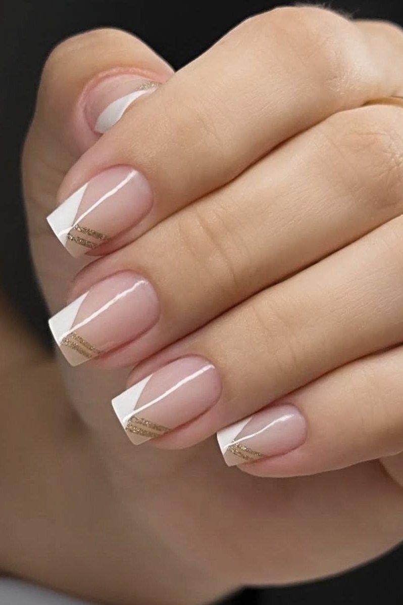 Elegant white diagonal French tips with gold ring accents for women over 40