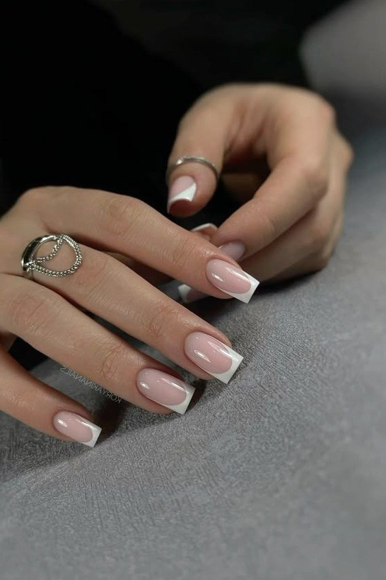 Elegant classic French tips at the salon, mid-manicure for women over 40