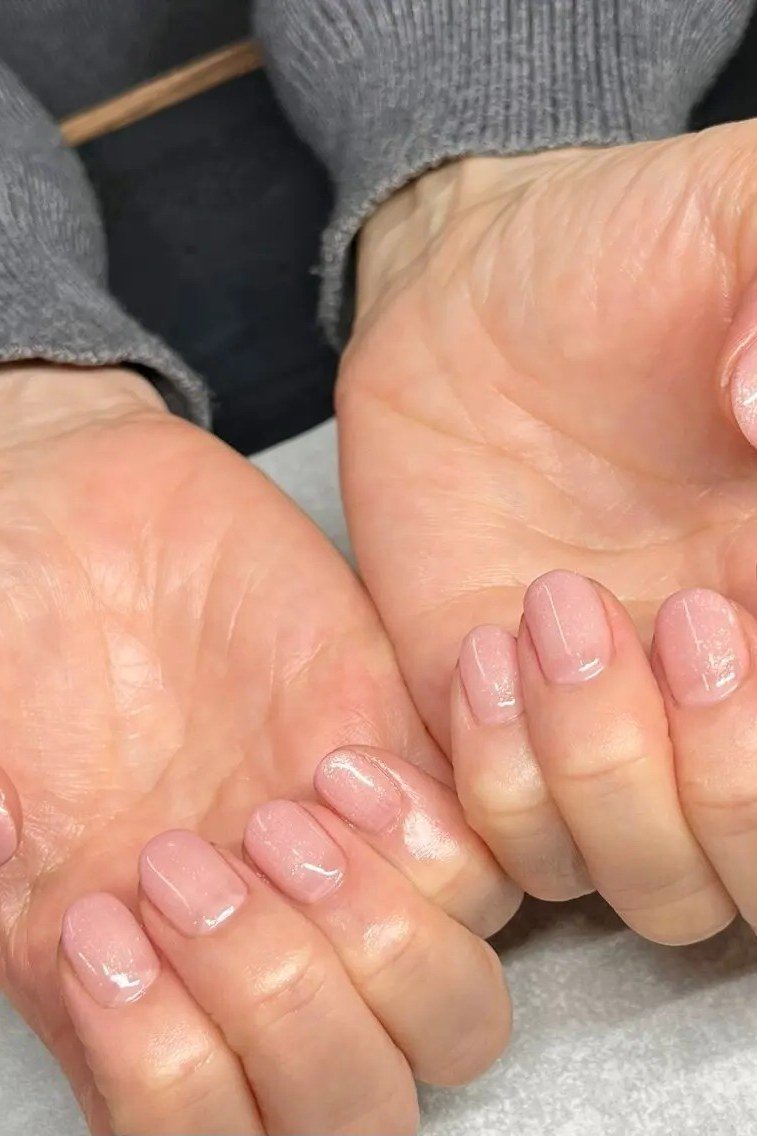 Elegant barely-there pale nails, natural healthy look for women over 40