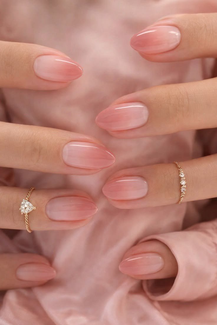 Elegant sheer pink almond nails on pink silk for women over 40