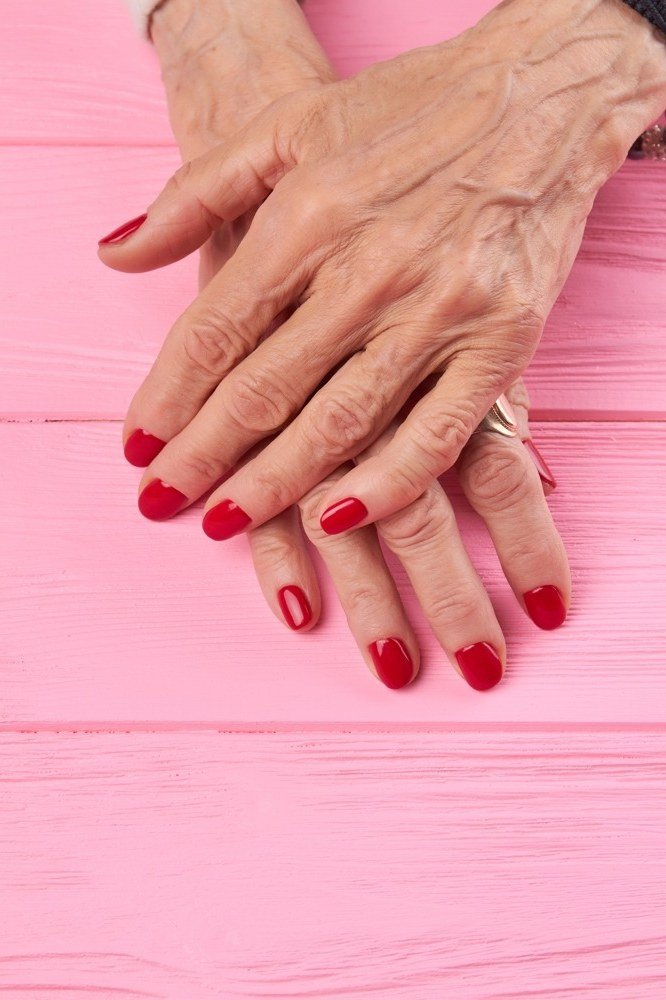 Red Nails on Pink Wood for women over 60 - simple nail tip 27