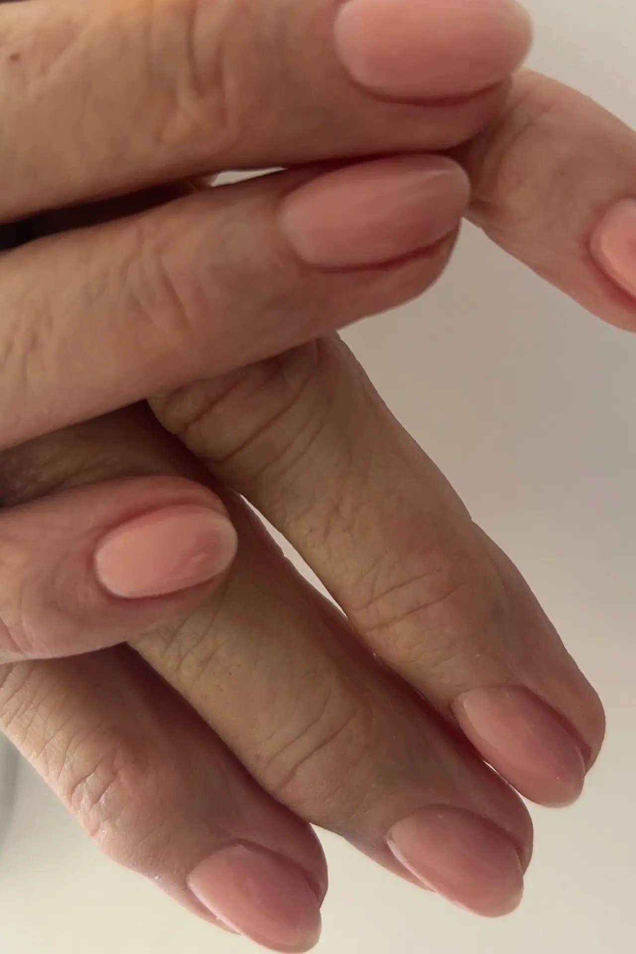 Coral oval nails, closeup of hands