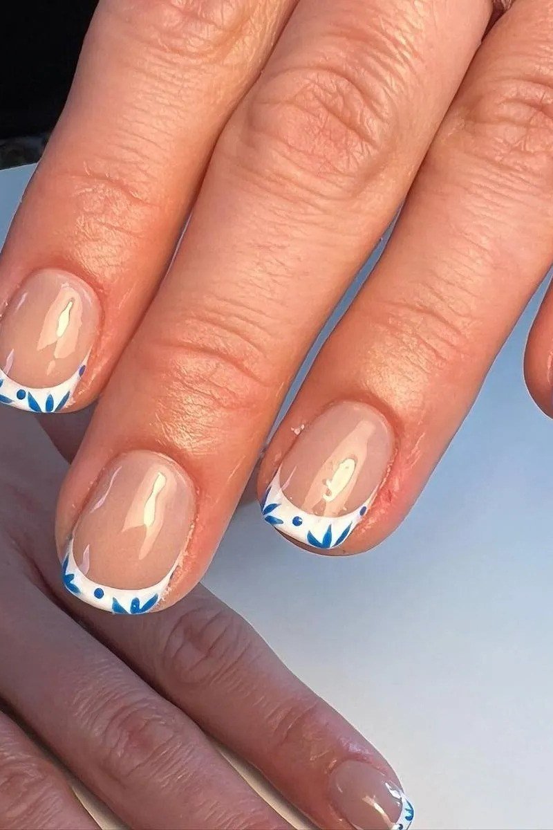 French tip squoval nails with blue art on white tips