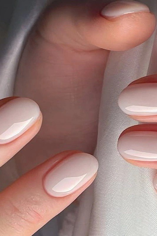 Nude oval nails, clean closeup of hands