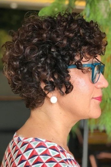 dark curly pixie haircut with glasses for women over 60