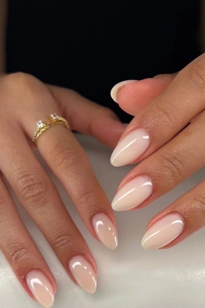 2. Warm Nude Almonds with Simple Gold Rings - nail art idea for women over 40