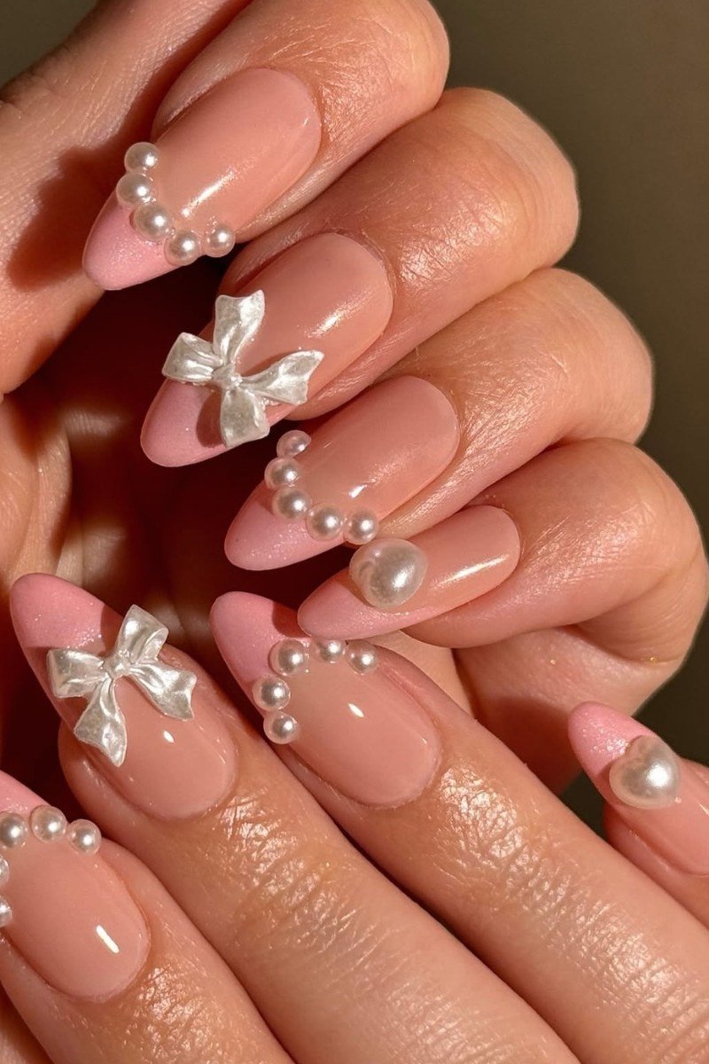 52. Pink Nails with Pearls and Bow Charms - nail art idea for women over 40