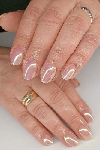Pearl chrome nails, mature hands with gold rings