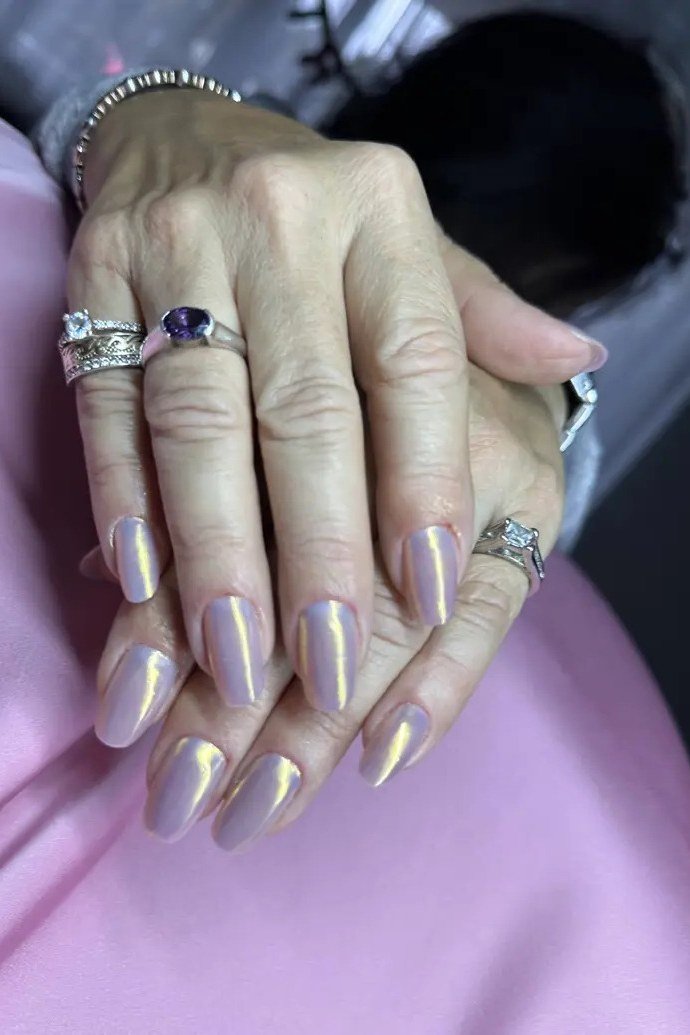 Holographic pearl almond nails, mature hands with rings